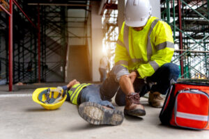 Construction worker assisting an injured colleague on a construction site