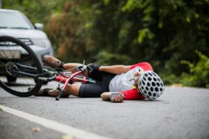 Cyclist lying injured on the road after an accident