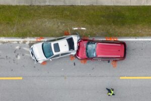 Aerial view of two cars involved in a head-on collision on a road