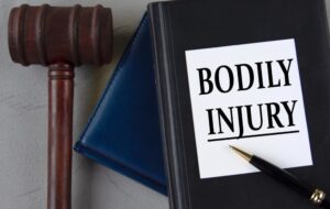 Books and pen with gavel on the table. The word bodily injured in written on the book cover