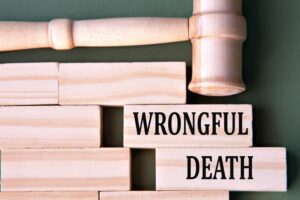 Wooden gavel with "Wrongful Death" text blocks, symbolizing legal accountability for manufacturer negligence.