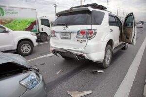 Road accident coupe gray hit the SUV car on the freeway in rush hour.