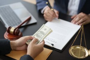 Close-up of a young lawyer signing a contract after finalizing a deal with a client.